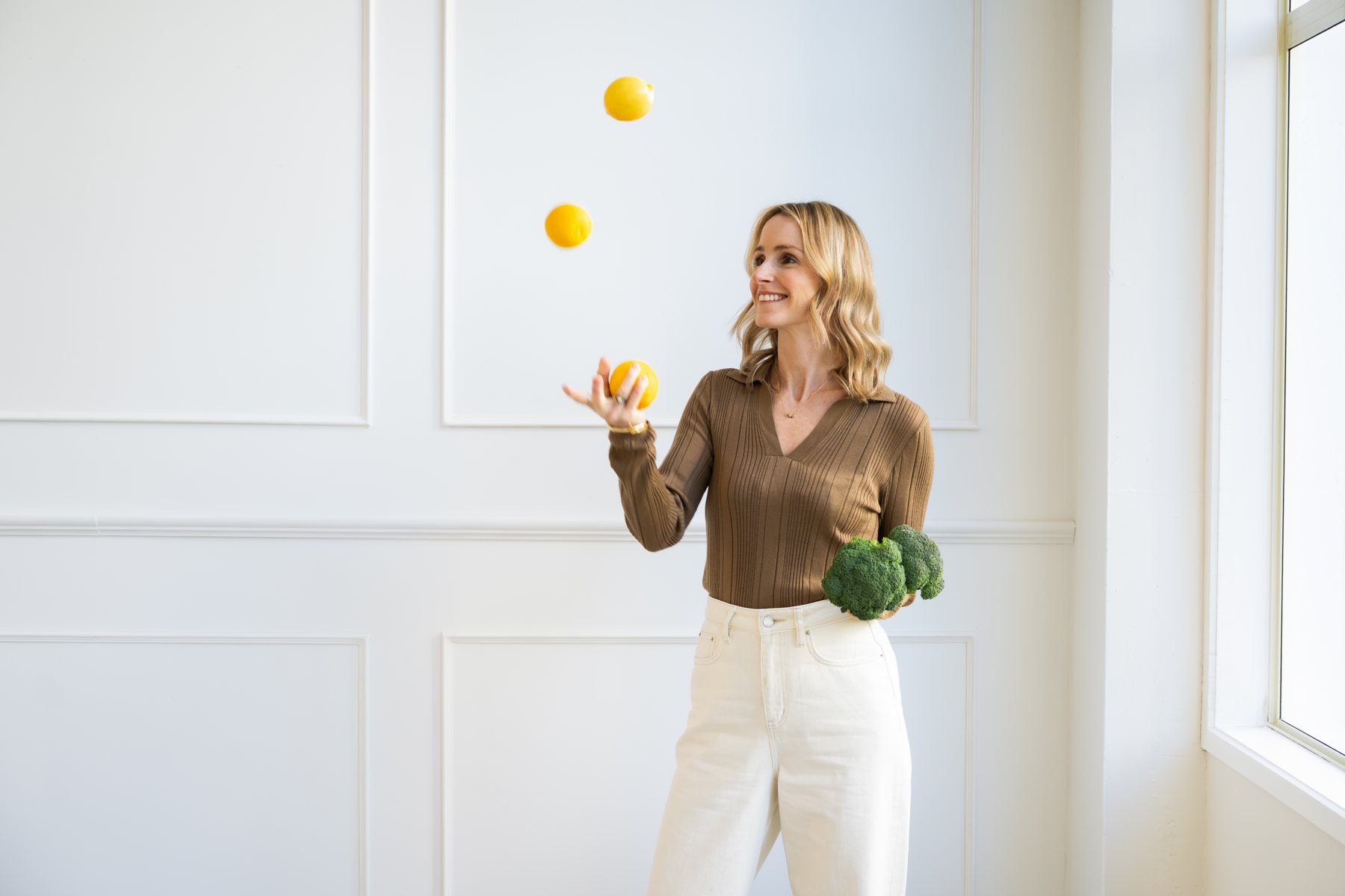 Natalie juggling lemons, holding broccoli